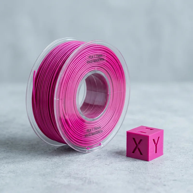 Magenta PLA filament coil beside a printed calibration cube